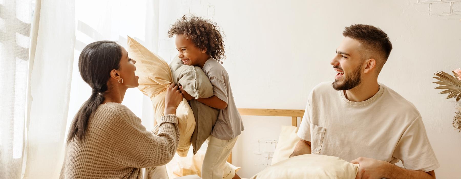 a family sitting on a bed