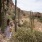a person standing next to a cactus